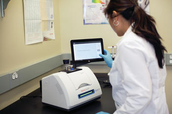 Thermo Scientific Nicolet Summit FTIR Spectrometer in use with touchscreen and LightBar engaged. 